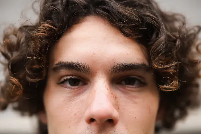 Real Reve Remix generation: A photorealistic portrait of a European man with thick eyebrows and eyelashes, light reali