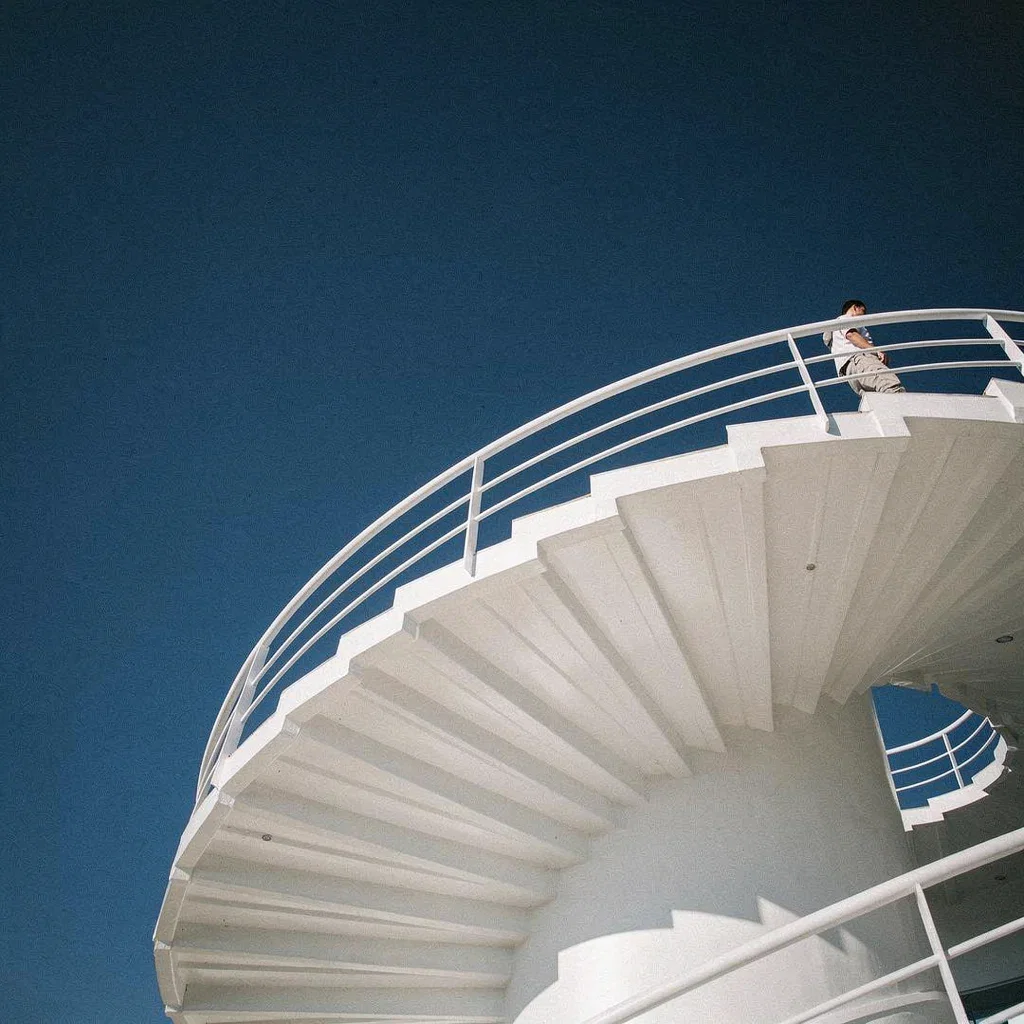 Instagram post of a white spiral staircase against a deep blue sky, generated on FluxoKit