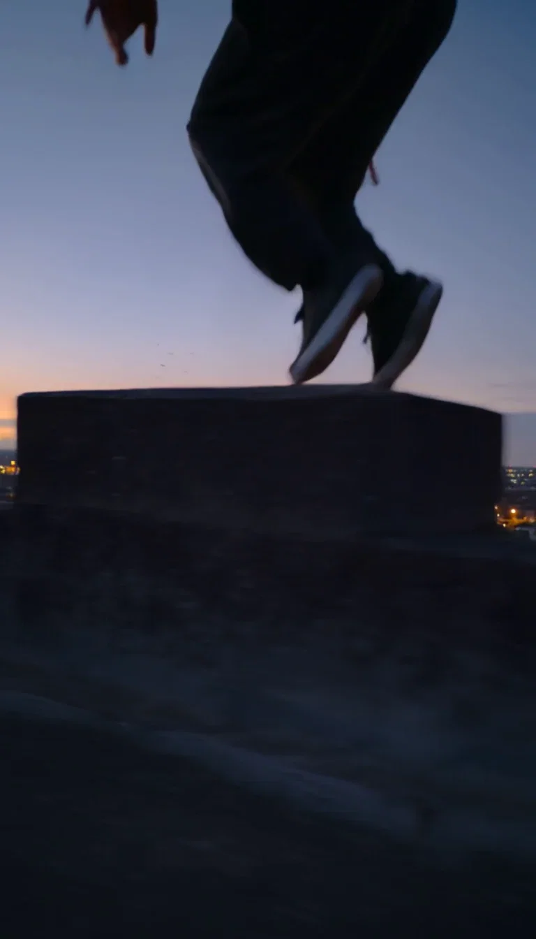 Vault impact beat frame with dust off the ledge from a Kling 2.6 clip on FluxoKit