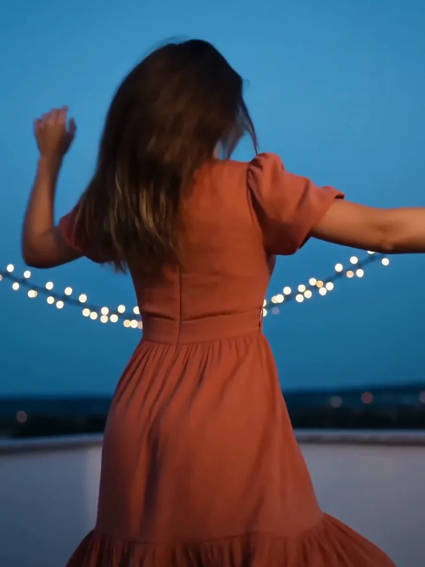 String lights bokeh over the rooftop terrace at blue hour, beat frame from a Seedance 2.0 clip on FluxoKit