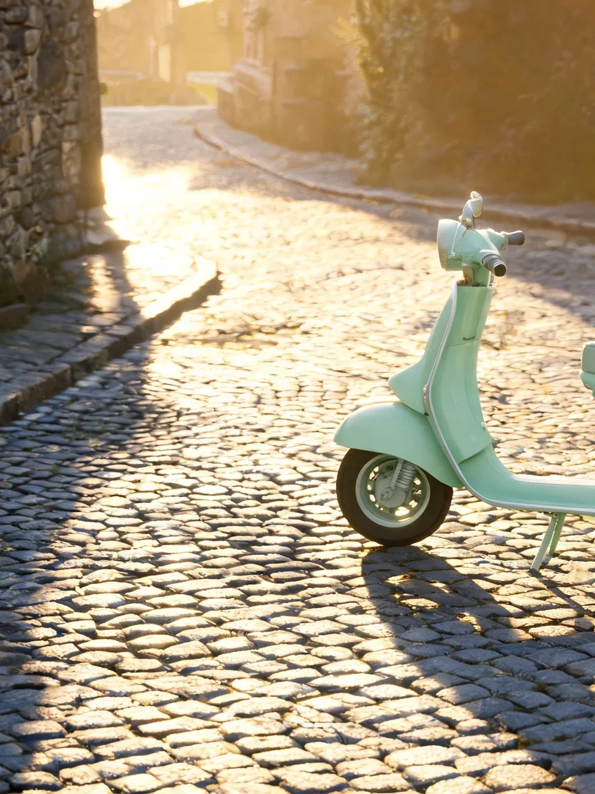 Plain mint scooter parked on a sunlit cobblestone lane, generated with Seedream 5 on FluxoKit