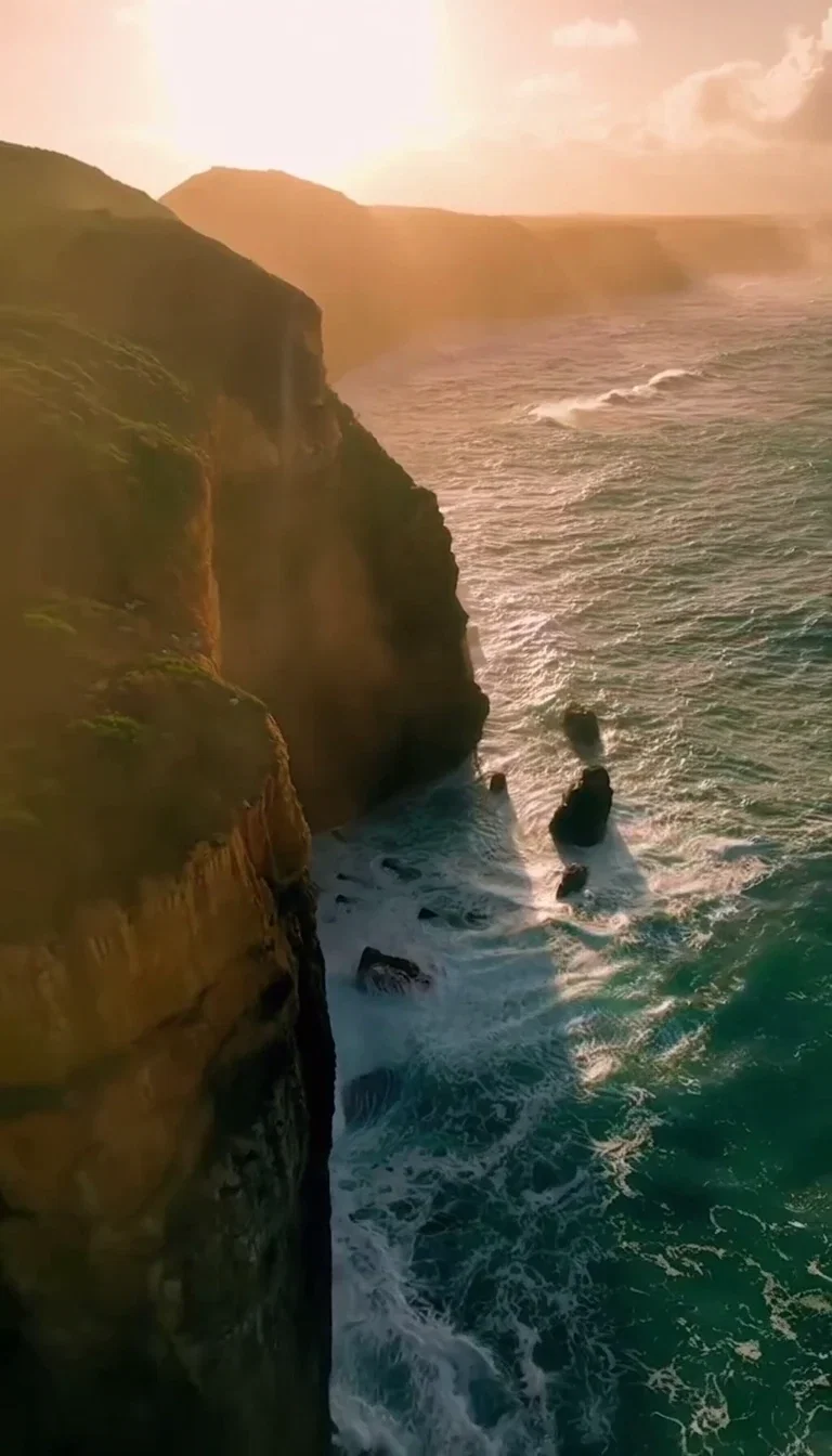 Closing beat of the Sora 2 Pro cliff aerial with sun haze over the sea, generated on FluxoKit