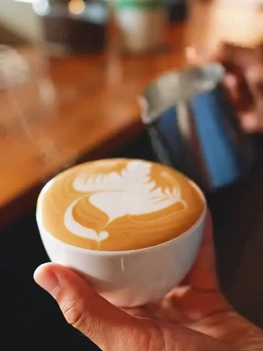 Frame of latte art forming in a cup from a Sora 2 clip, generated on FluxoKit