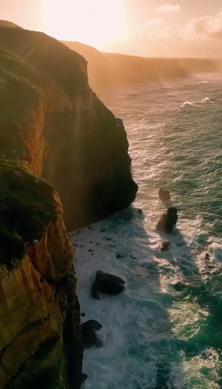 Thumbnail for Sora 2 video example: golden-hour sea cliff aerial